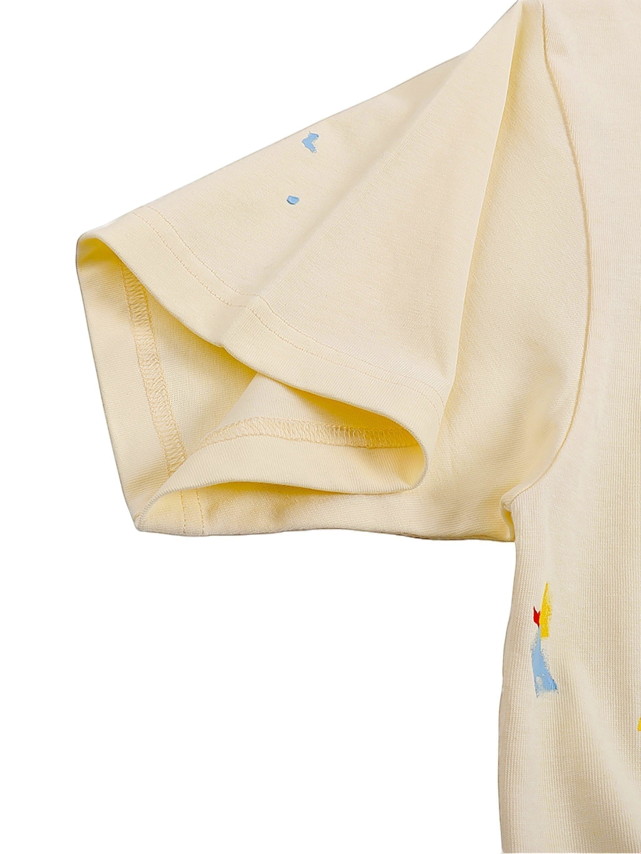 VaultWear cream cotton t-shirt sleeve with artistic multi-colored paint splatter details