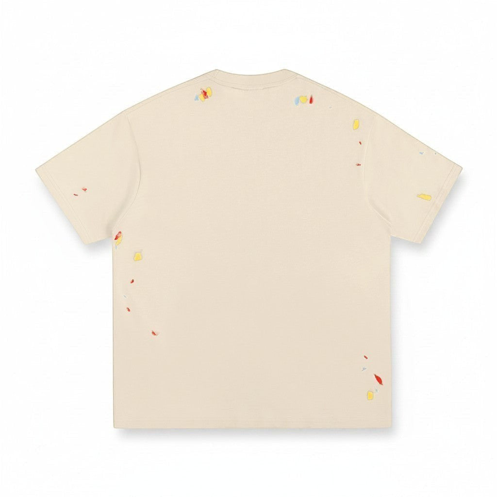 Back view of VaultWear cream cotton t-shirt with multi-colored paint splatter details and a relaxed crewneck fit.