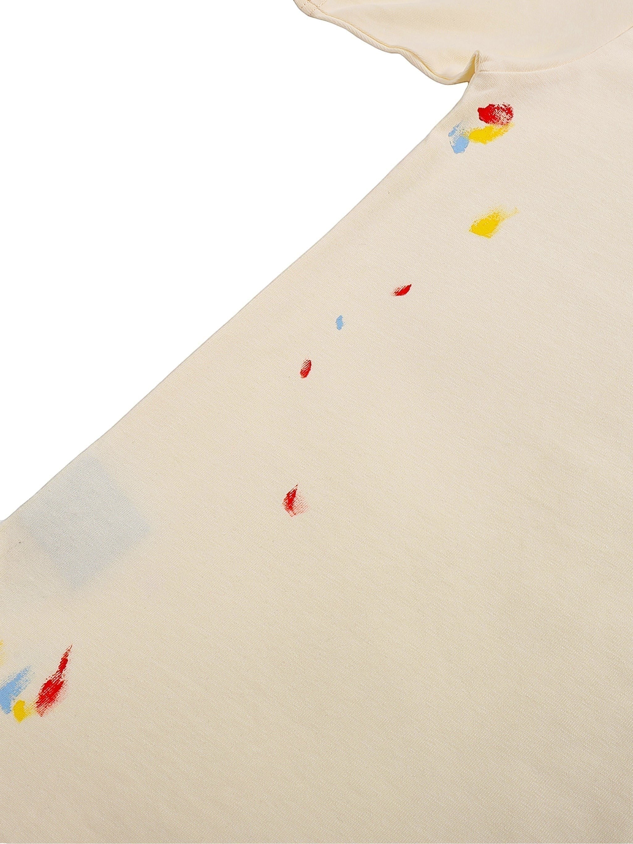 VaultWear cream cotton t-shirt featuring artistic multi-colored paint splatter details on the fabric.