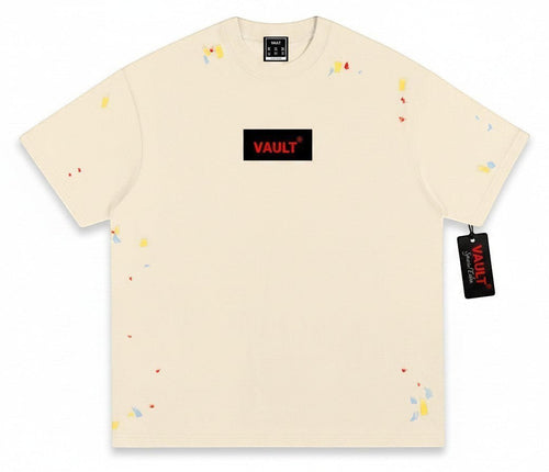VaultWear cream cotton crewneck t-shirt featuring a black logo patch with red text and multi-colored paint splatters.